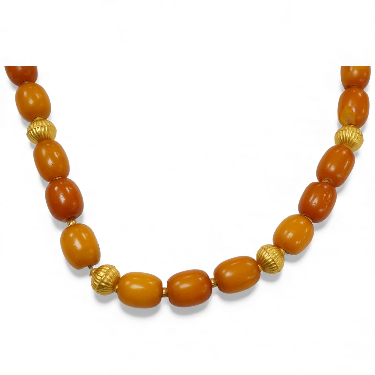 An amber and gold necklace, composed of amber beads measuring approximately 0.6 - 1.1cm, to a clasp and fluted spacer beads in gold, length 46cm, stamped 750, gross weight approximately 34 grams